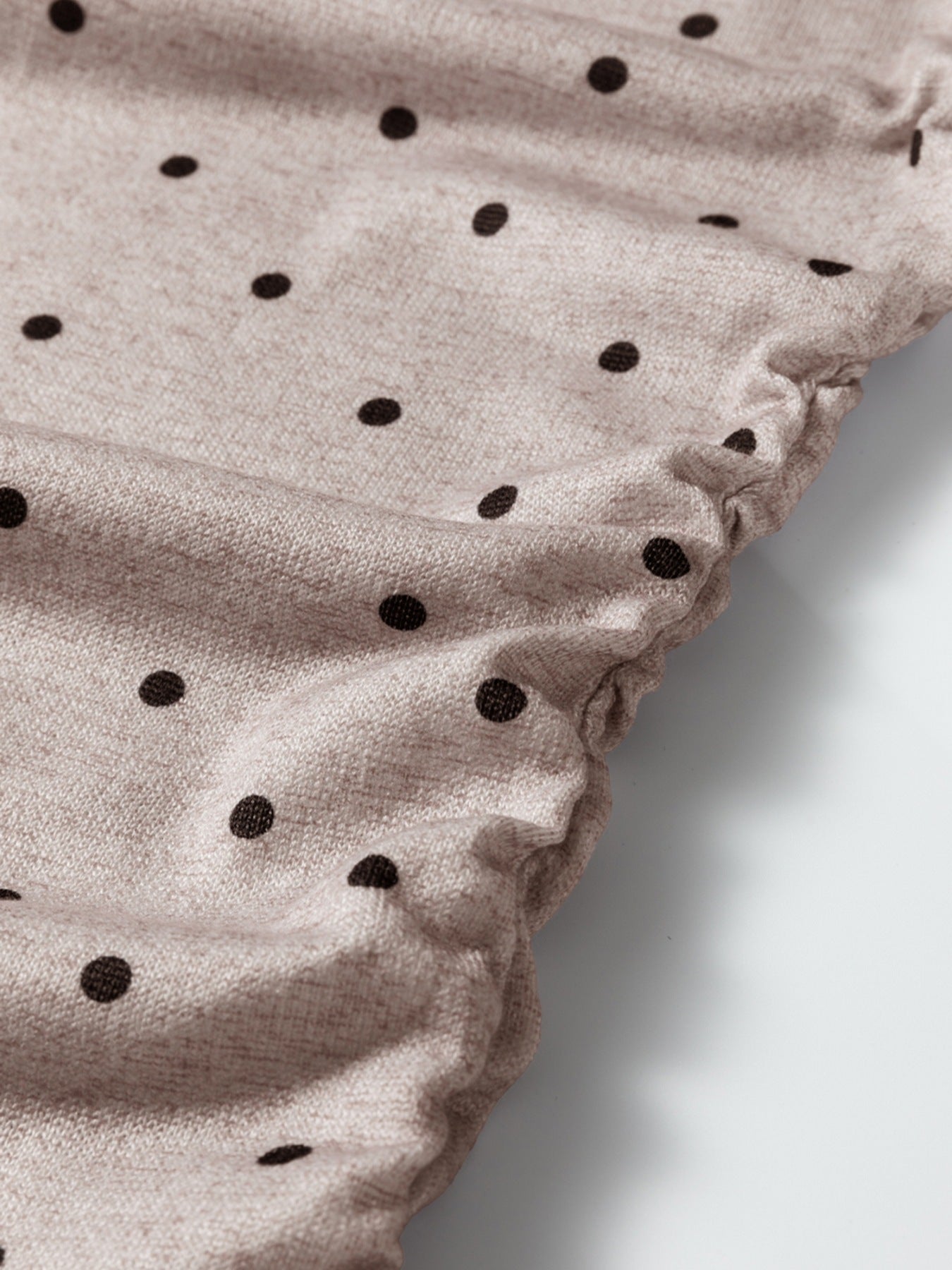 Boat neck polka dot long-sleeve tee in khaki with a textured knit fabric and gathered hem detail.