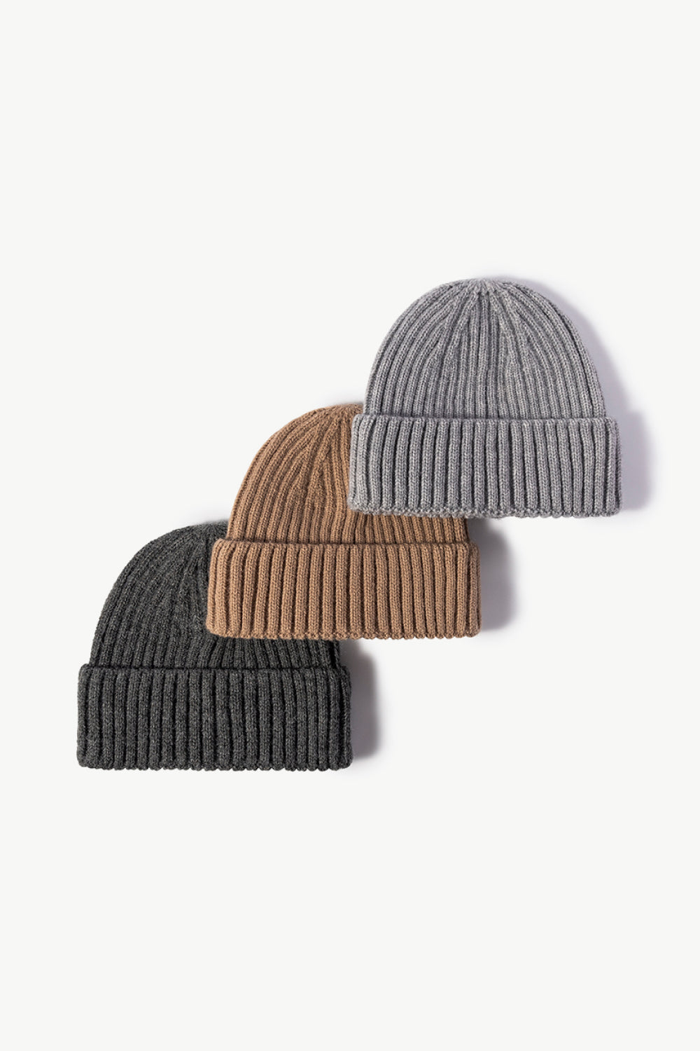 Chunky ribbed knit beanies in dark gray, brown, and gray acrylic.