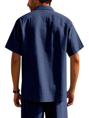 Classic short sleeve button-down shirt in navy blue with a collared neckline and textured fabric.