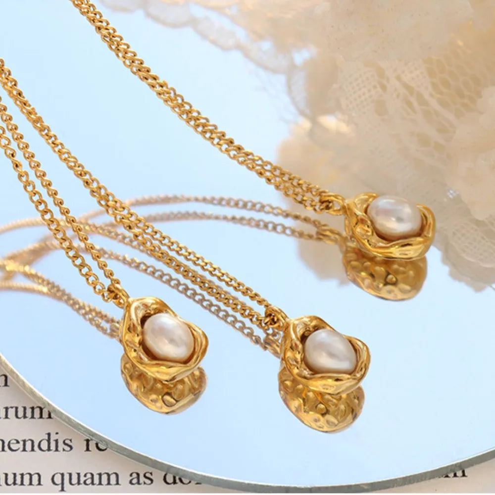 Gold necklace with pearl charm and textured setting
