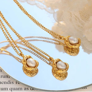 Gold necklace with pearl charm and textured setting