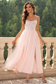 Blush pink tulle maxi dress with sequin bodice and double thigh slits.