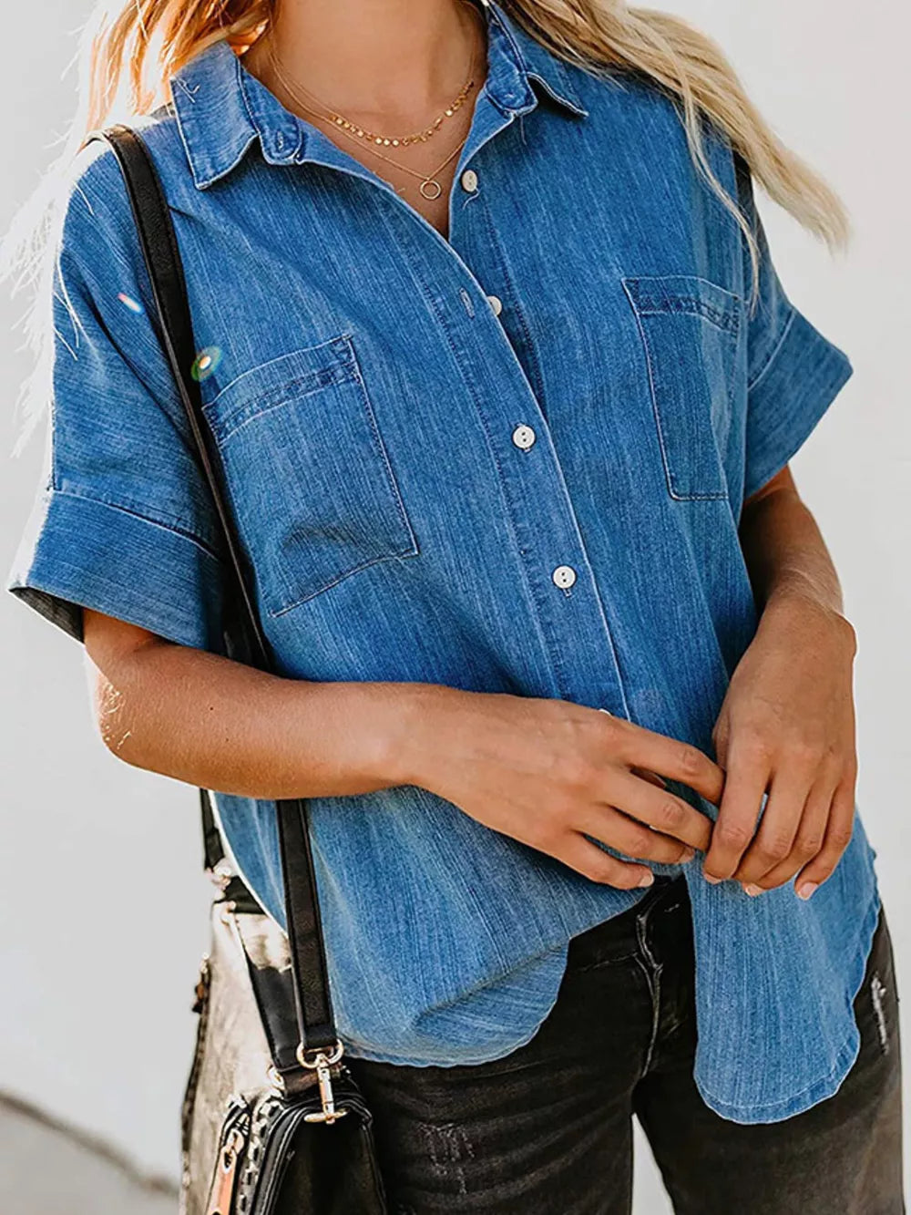 Denim button-front shirt in dark blue with short sleeves and two chest pockets.