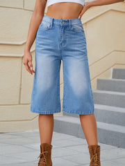 Medium wash denim culotte bermuda shorts with a wide leg and frayed hem.