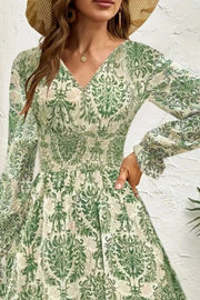 Green printed maxi dress with bishop sleeves and cinched waist