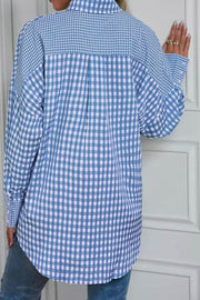 Light blue gingham oversized shirt with button cuffs and a patch pocket detail.