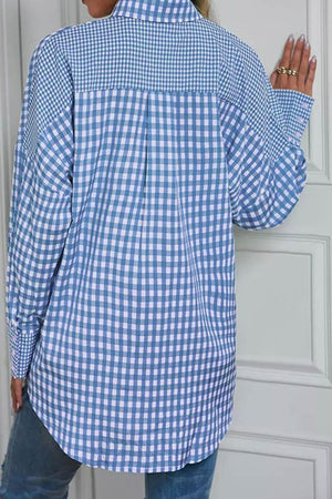 Light blue gingham oversized shirt with button cuffs and a patch pocket detail.