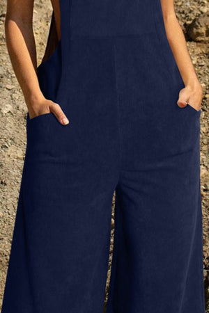 Dark Blue corduroy overalls with wide leg silhouette and front pockets.