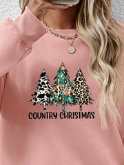 Blush pink crewneck sweatshirt with country Christmas trees graphic and text.