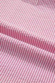 Pink and white striped textured polyester short sleeve blouse fabric detail