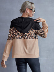 Black colorblock leopard print zip-up hoodie with waffle knit fabric and tan sleeves.