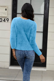 Light blue fluffy knit cardigan with long sleeves, worn with jeans.