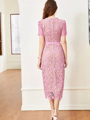 Pink lace midi dress with short sleeves, belted waist, and back zipper detail.