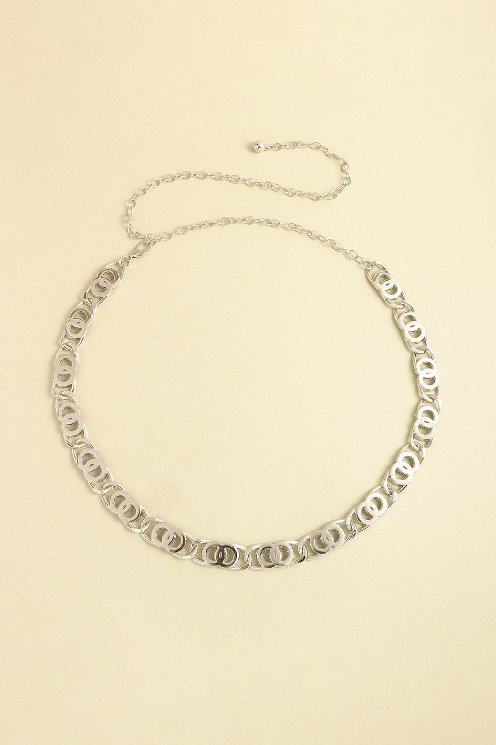 Silver chain belt with interlocking circle links and adjustable extender chain.