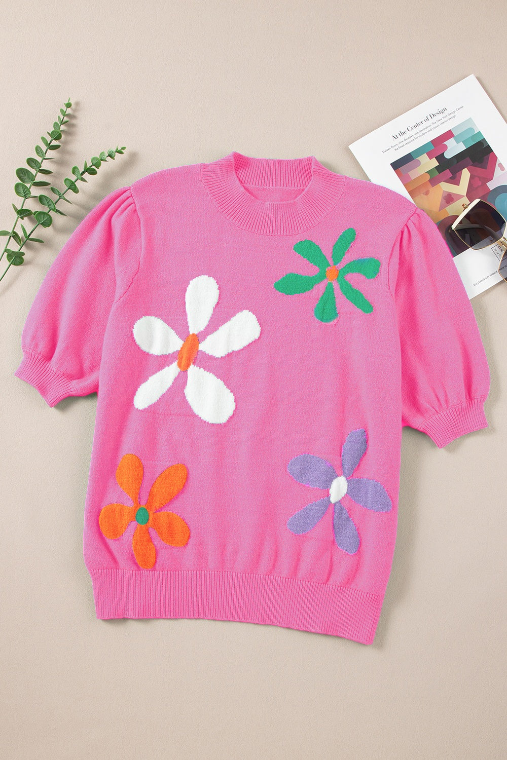 Pink knit sweater with puff sleeves and colorful floral appliques