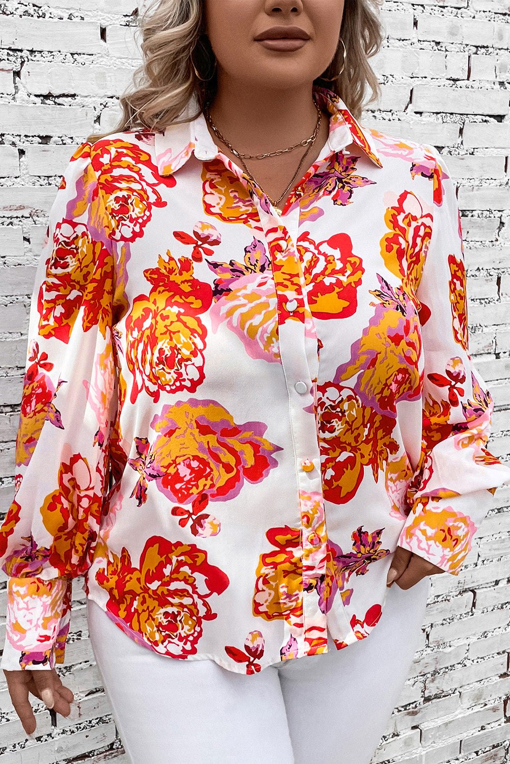 Blouse with blouson sleeves in a bold floral print, featuring a collared neckline and button-up front.