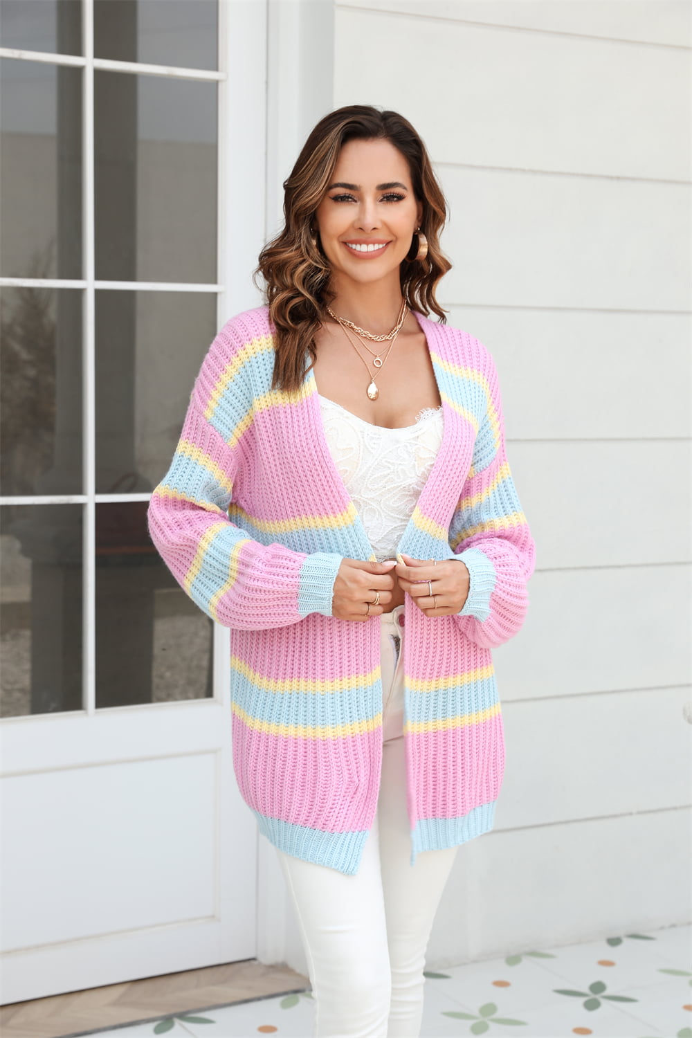 Open knit cocoon cardigan with rainbow stripes in pink, blue, and yellow acrylic.