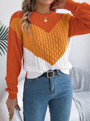 Chevron cable knit sweater with contrast orange, yellow, and white panels.