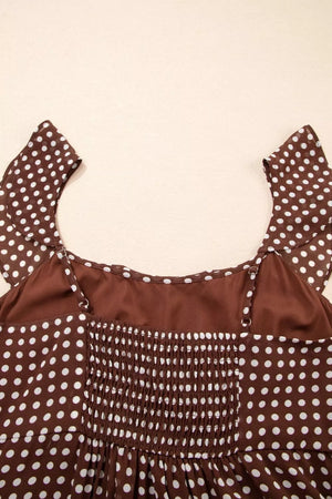 Brown polka dot maxi dress with smocked bodice and ruffled sleeves.