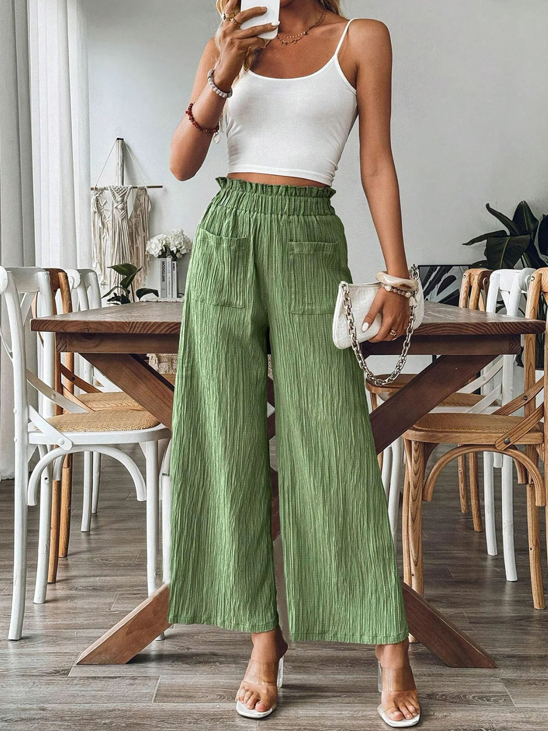 Green textured gauze palazzo trousers with elastic waist and pockets.