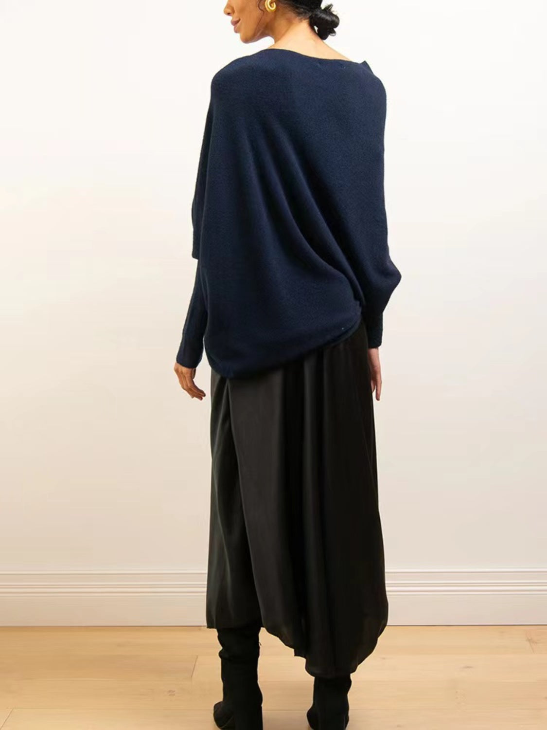Dark blue off-shoulder drape knit sweater with textured cuffs and batwing sleeves.