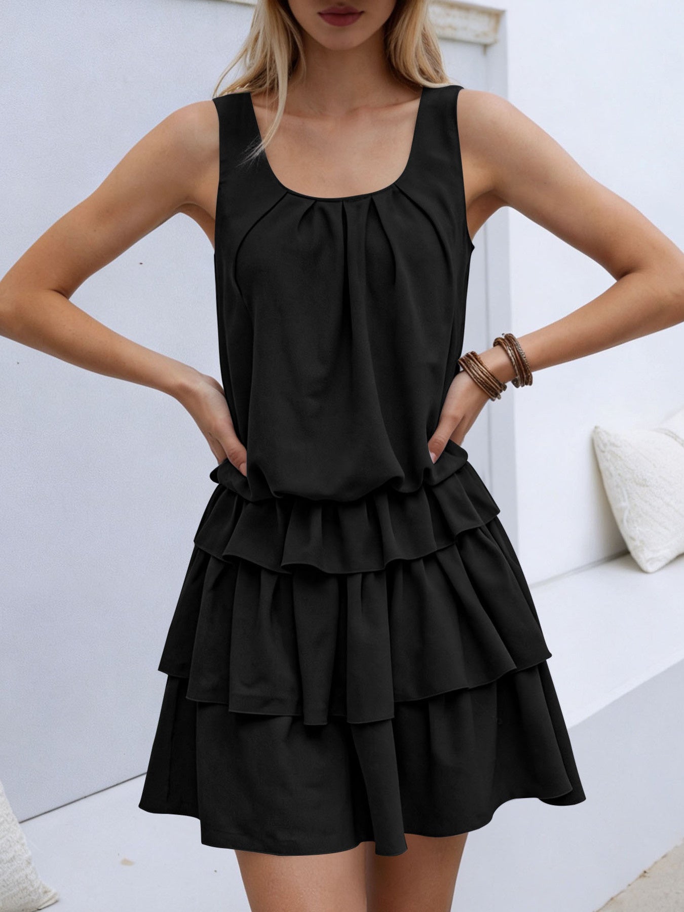 Black ruffled tiered mini dress with a gathered neckline and elastane.