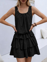 Black ruffled tiered mini dress with a gathered neckline and elastane.
