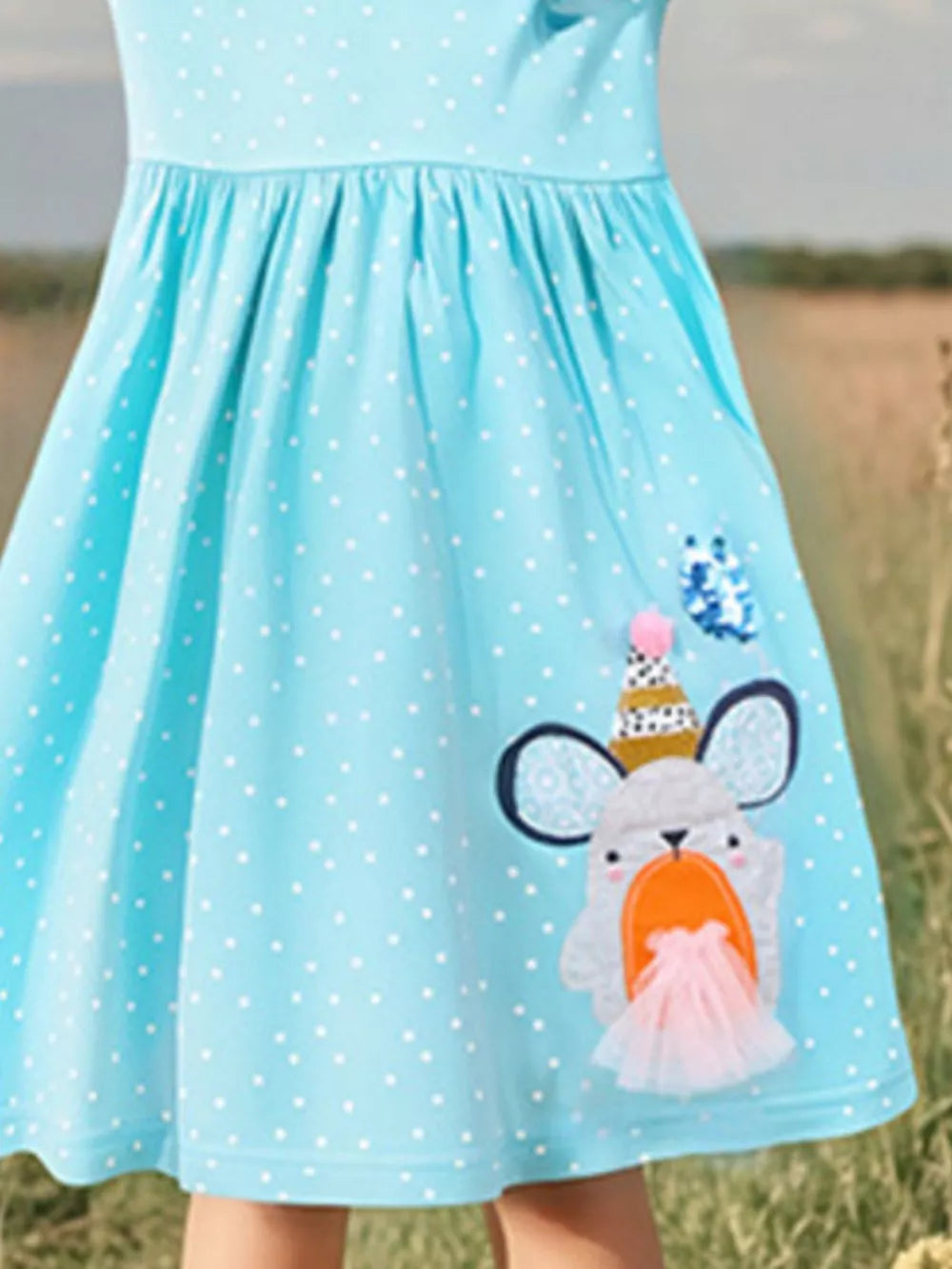 Mint blue polka dot toddler dress with cartoon mouse applique and tulle skirt detail.