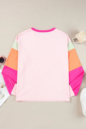 Colorblock long sleeve t-shirt in blush pink with colorblocked sleeves in green, orange, and pink.