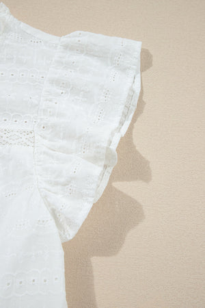 White eyelet yoke blouse with ruffle sleeves and intricate embroidery detail.