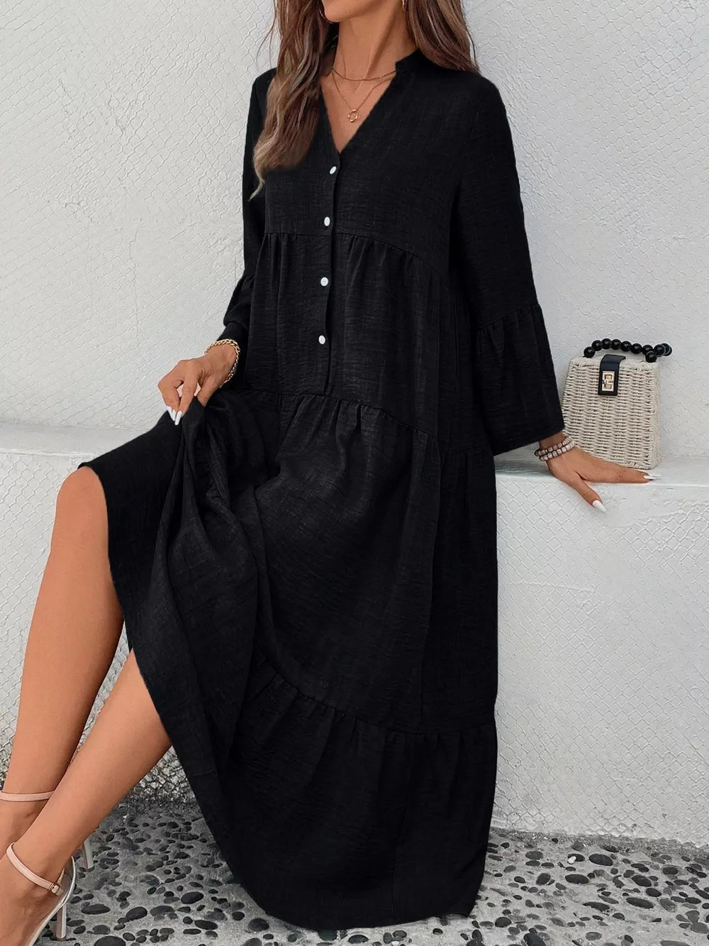 Black tiered ruffle hem v-neck dress with button front and bell sleeves.
