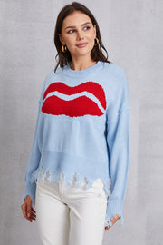 Light blue acrylic sweater with red kiss graphic and distressed hem
