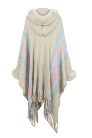 Textured stripe poncho with faux fur trim, hood, and fringe detail.