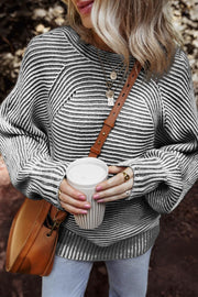 Textured stripe batwing knit sweater in black and gray with a relaxed fit and crew neck.
