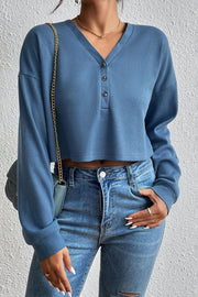 Dusty blue waffle knit henley crop top with button detail and long sleeves