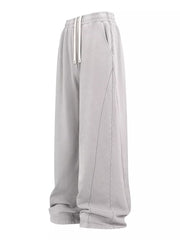 Light gray drawstring wide leg sweatpants with contrast stitching and pockets.