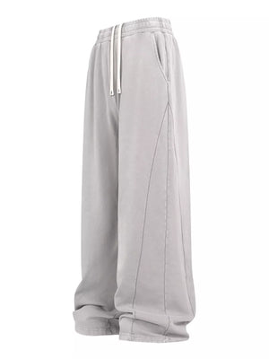 Light gray drawstring wide leg sweatpants with contrast stitching and pockets.