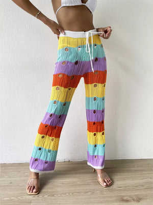 Vibrant crochet knit maternity pants with rainbow stripes and cutout details.