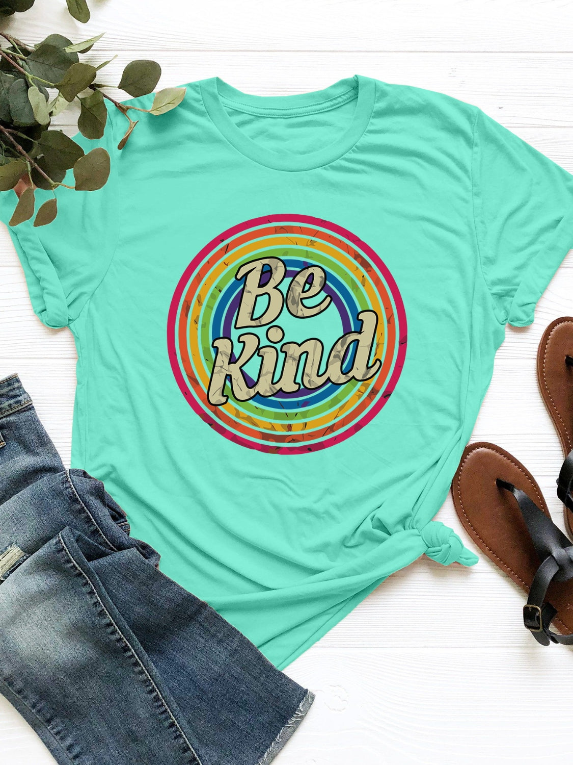 Tiffany Blue graphic tee with "Be Kind" text in a retro circle design