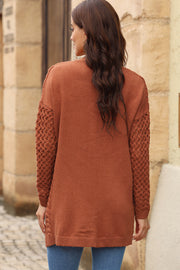 Textured open-knit pocket cardigan in caramel with open knit sleeves and side detail.