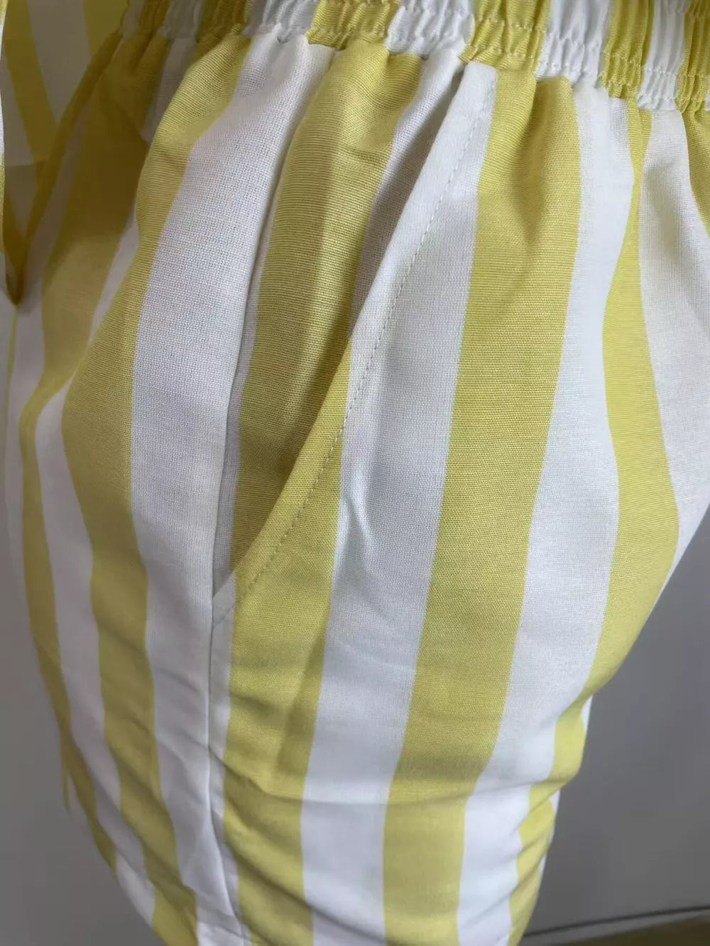 Yellow and white striped two-piece set shorts with pockets and elastic waistband.