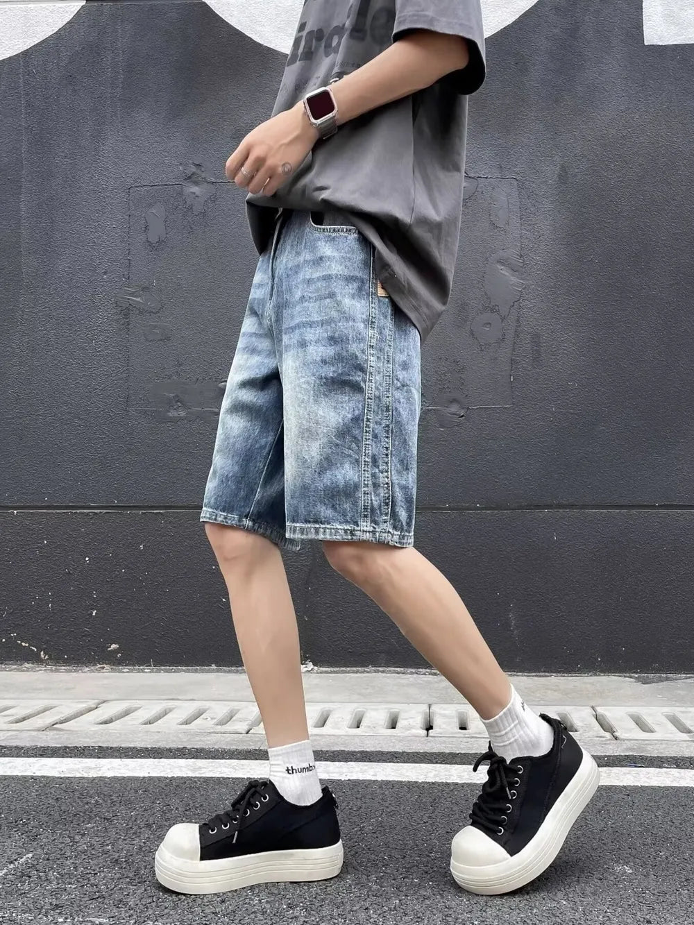 Relaxed fit blue denim shorts with a faded wash and whiskering detail.