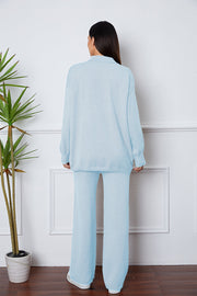 Relaxed knit polo co-ord set in Misty Blue, featuring a collared long-sleeve top and wide-leg pants.