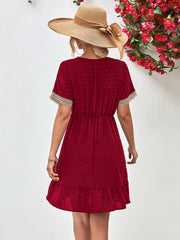 Burgundy Swiss dot dress with crochet trim, elastic waist, and ruffled hem.