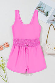 Fuchsia pink active romper with scoop neck, ruched drawstring waist and short shorts.