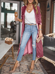 Burgundy velvet duster coat with fluid silhouette, open front, long sleeves, and a pink lining.