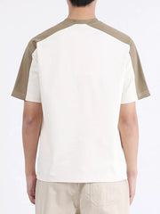 Men's contrast stitch t-shirt in cream with tan raglan sleeves and visible stitching detail.