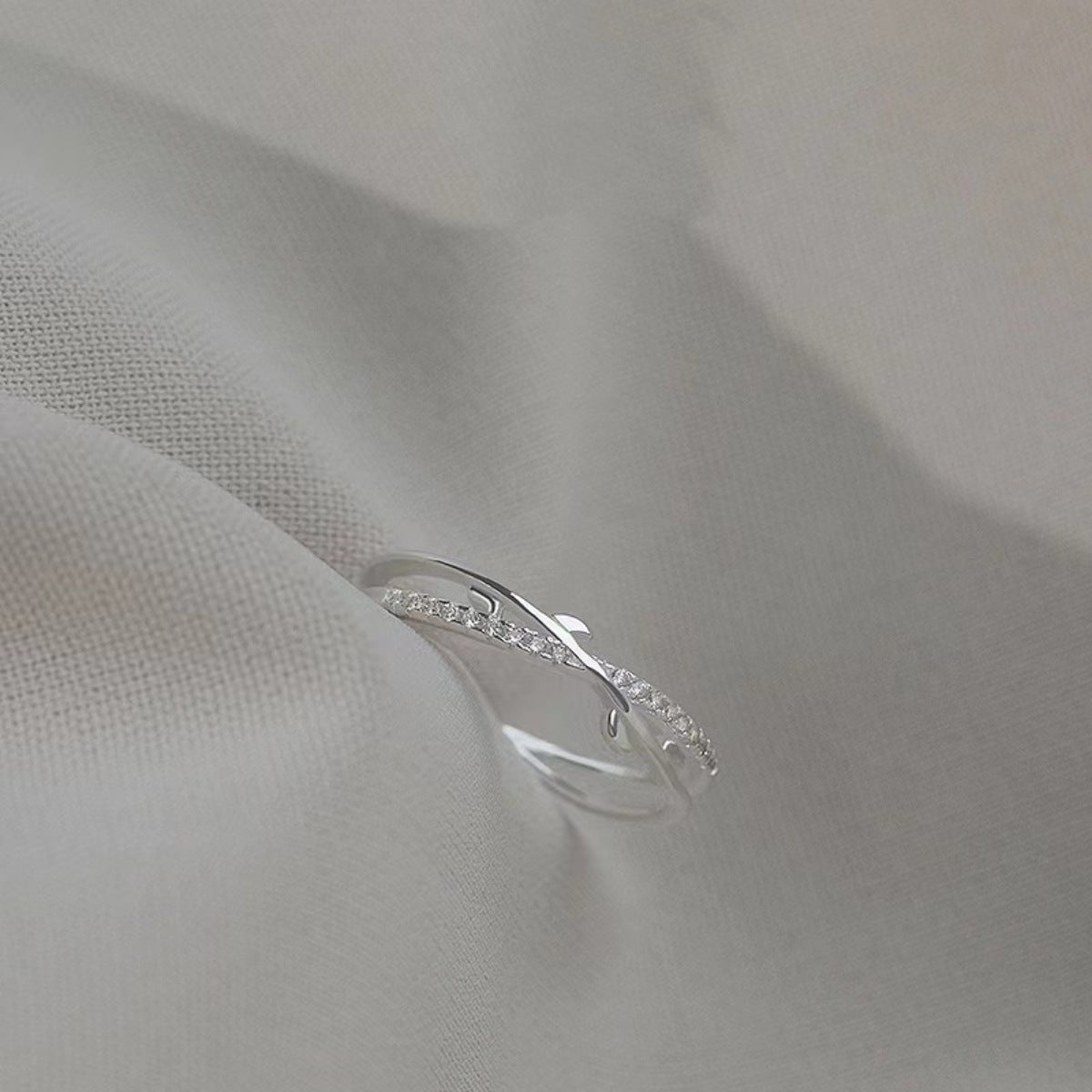 Sterling silver crossover ring with delicate pave crystal accents