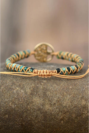 Gold Tree of Life macrame bracelet with turquoise and black beads and adjustable cord.