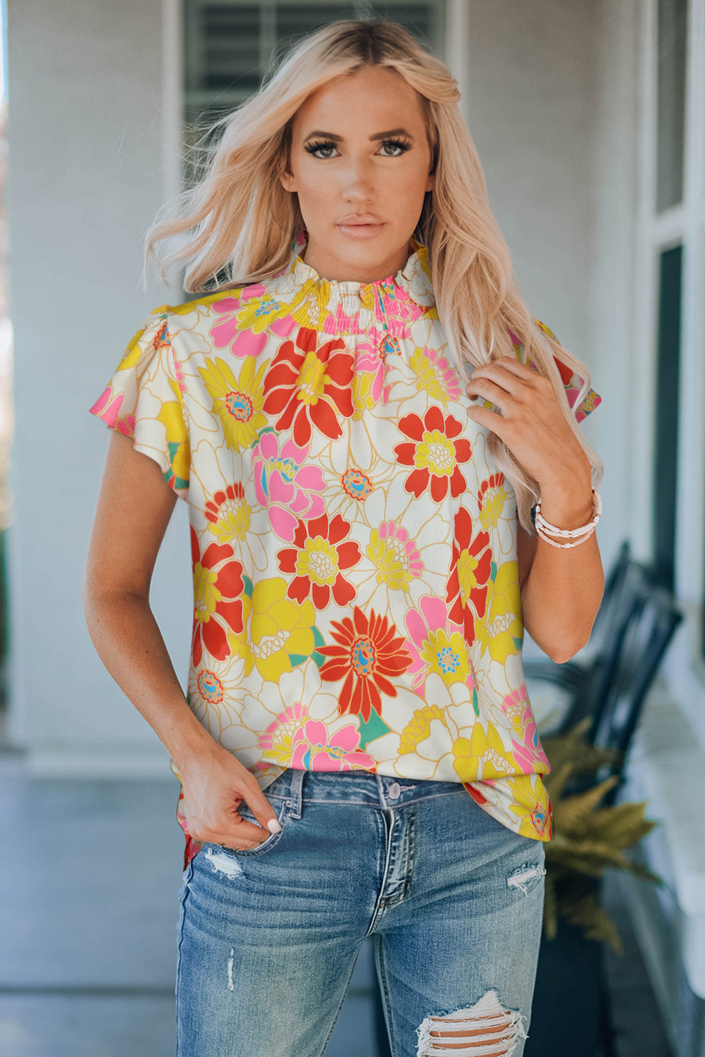 Floral blouse with smocked neckline and butterfly sleeves